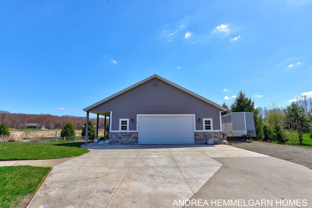 4459 36th St, Hamilton, MI 49419 - view of front of property featuring stone siding and a detached garage