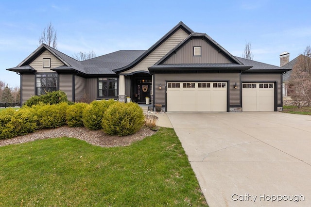 craftsman house with a garage, driveway, and a front lawn
