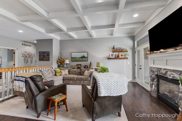 living area featuring wood finished floors, beam ceiling, and coffered ceiling