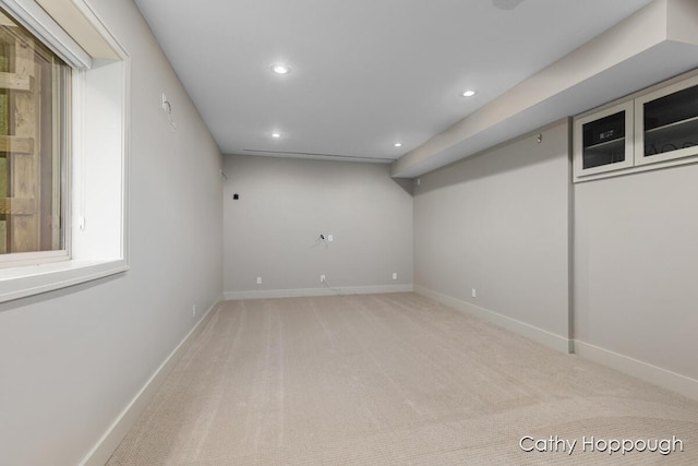 finished basement featuring light colored carpet, baseboards, and recessed lighting