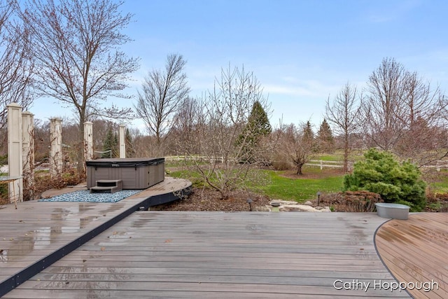 wooden deck with a hot tub