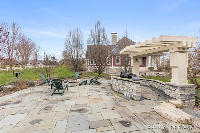 view of patio featuring a fire pit and a pergola