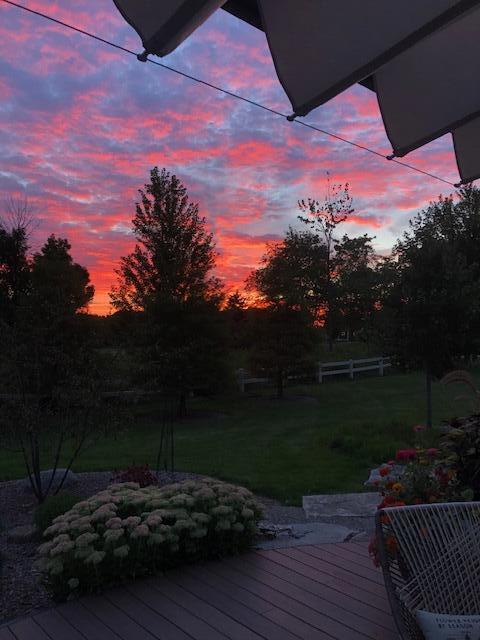 deck at dusk featuring a yard
