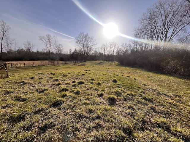 view of yard with a rural view and fence