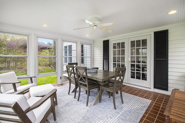 sunroom / solarium with outdoor dining area, ceiling fan, and french doors