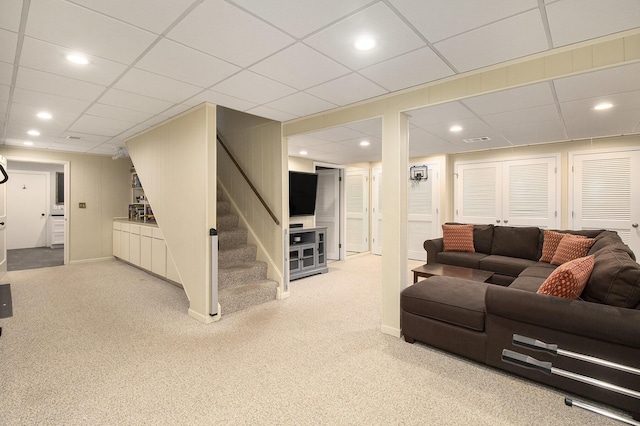 carpeted living area with recessed lighting, stairs, a drop ceiling, and visible vents