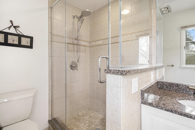 bathroom featuring crown molding, vanity, a stall shower, and toilet