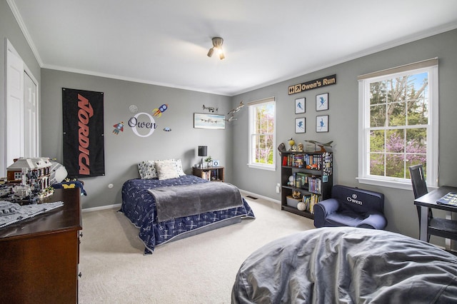 bedroom with crown molding, baseboards, and carpet flooring