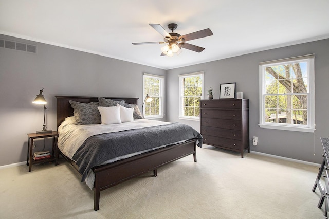 bedroom with baseboards, visible vents, ornamental molding, and light carpet