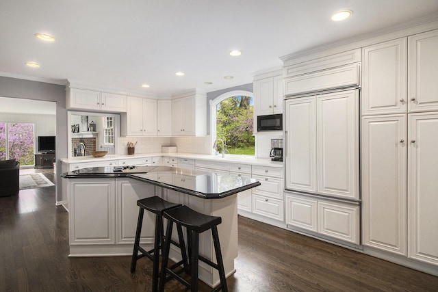 kitchen with black appliances, recessed lighting, and white cabinetry