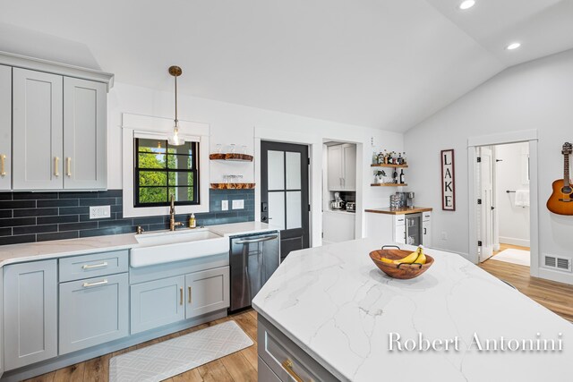 2301 Schimperle Dr NE, Grand Rapids, MI 49525 - kitchen featuring open shelves, stainless steel dishwasher, a sink, lofted ceiling, and light wood-style floors