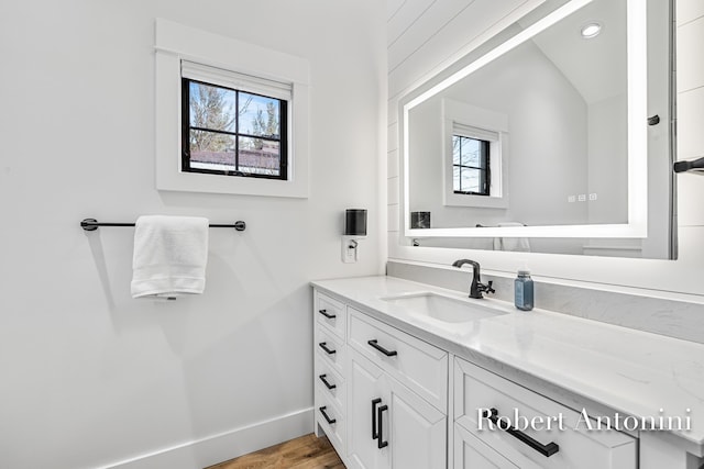 2301 Schimperle Dr NE, Grand Rapids, MI 49525 - bathroom with vanity, wood finished floors, and baseboards