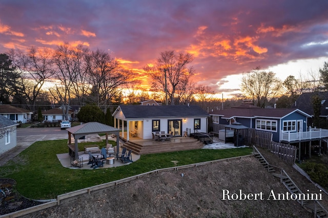 2301 Schimperle Dr NE, Grand Rapids, MI 49525 - rear view of house featuring a deck, a gazebo, a yard, and a patio