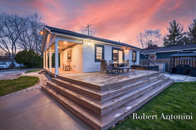 2301 Schimperle Dr NE, Grand Rapids, MI 49525 - deck at dusk with a gazebo and outdoor dining area