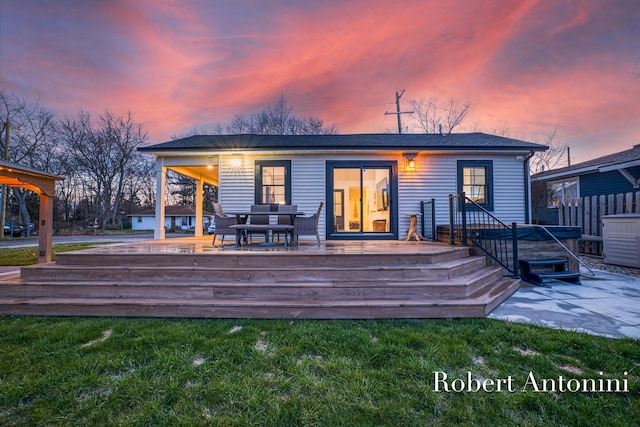 2301 Schimperle Dr NE, Grand Rapids, MI 49525 - back of property at dusk featuring a deck