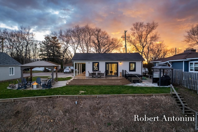 2301 Schimperle Dr NE, Grand Rapids, MI 49525 - rear view of property featuring a gazebo, a wooden deck, and an outdoor fire pit