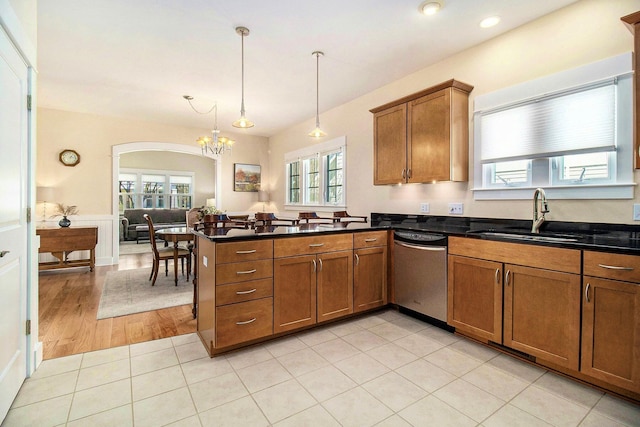 8 Georgia Ct, Pentwater, MI 49449 - kitchen with brown cabinets, a sink, dishwasher, plenty of natural light, and a peninsula