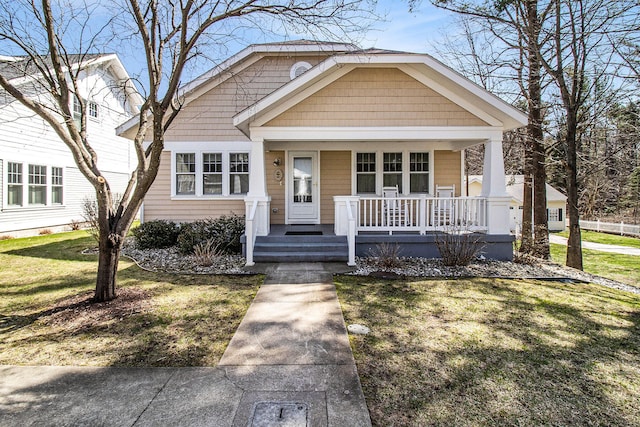8 Georgia Ct, Pentwater, MI 49449 - bungalow featuring a porch and a front yard