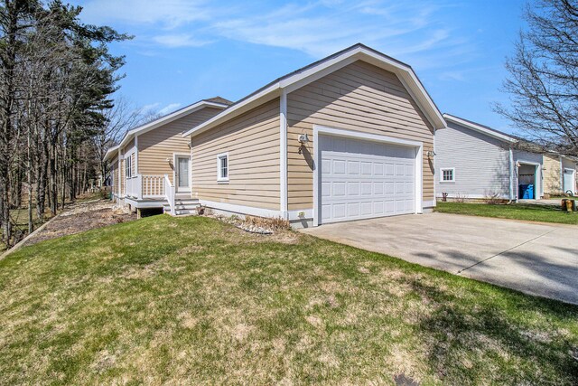 8 Georgia Ct, Pentwater, MI 49449 - view of property exterior with a lawn, an attached garage, and concrete driveway