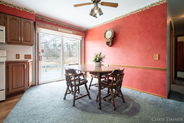15230 Van Buren St Unit B, Holland, MI 49424 - dining area featuring baseboards, a ceiling fan, and carpet flooring