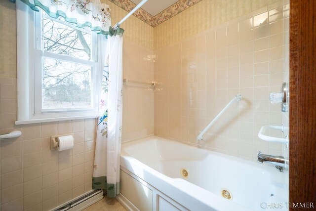 15230 Van Buren St Unit B, Holland, MI 49424 - bathroom featuring tile walls, a combined bath / shower with jetted tub, and a baseboard heating unit