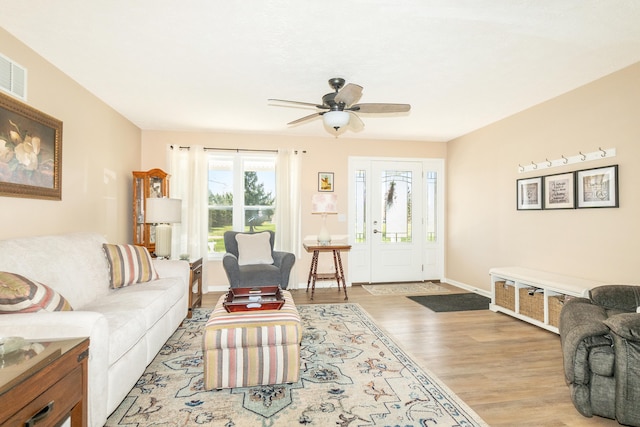48320 Martz Rd, Van Buren Twp, MI 48111 - living room featuring baseboards, a ceiling fan, visible vents, and light wood finished floors