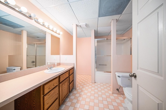 2925 Exmoor Rd, Ann Arbor, MI 48104 - bathroom with toilet, a drop ceiling, vanity, and shower / bath combination with glass door