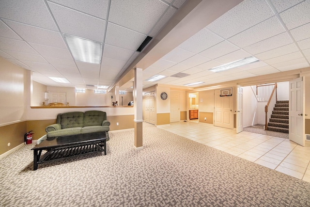 2925 Exmoor Rd, Ann Arbor, MI 48104 - finished below grade area featuring stairs, a paneled ceiling, baseboards, and tile patterned flooring
