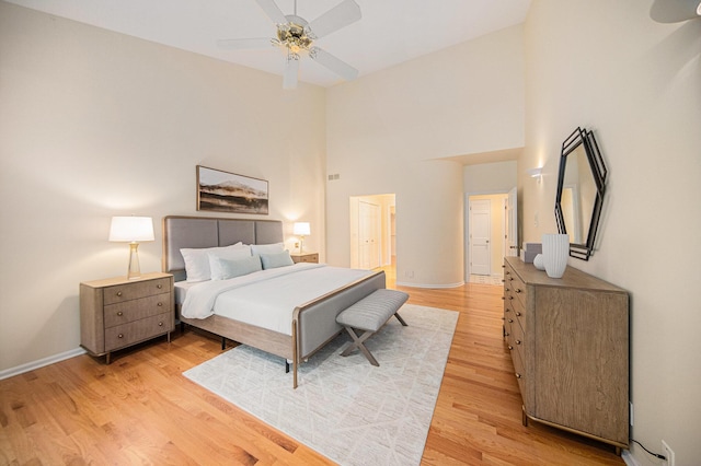 2925 Exmoor Rd, Ann Arbor, MI 48104 - bedroom with light wood-style flooring, a towering ceiling, baseboards, and a ceiling fan