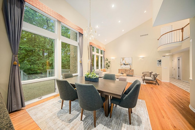 2925 Exmoor Rd, Ann Arbor, MI 48104 - dining area featuring high vaulted ceiling, light wood finished floors, a chandelier, and recessed lighting