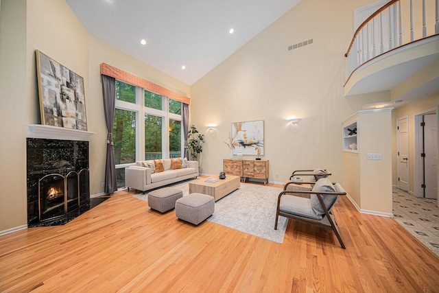 2925 Exmoor Rd, Ann Arbor, MI 48104 - living room featuring wood finished floors, high vaulted ceiling, a premium fireplace, baseboards, and recessed lighting