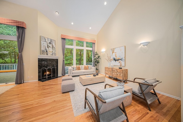 2925 Exmoor Rd, Ann Arbor, MI 48104 - living room featuring high vaulted ceiling, a premium fireplace, wood finished floors, baseboards, and recessed lighting