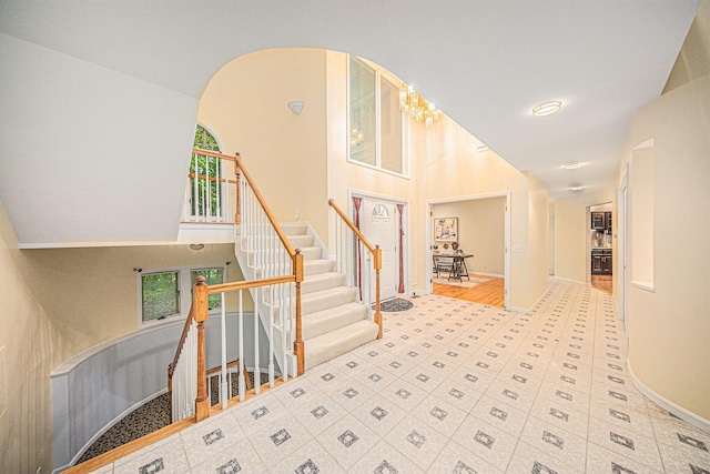 2925 Exmoor Rd, Ann Arbor, MI 48104 - entrance foyer with healthy amount of natural light, a towering ceiling, baseboards, and stairway