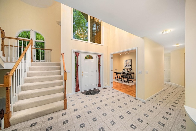 2925 Exmoor Rd, Ann Arbor, MI 48104 - foyer featuring stairway, baseboards, and a towering ceiling