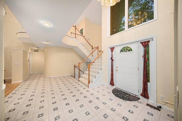 2925 Exmoor Rd, Ann Arbor, MI 48104 - foyer entrance featuring stairway, a chandelier, baseboards, and a towering ceiling