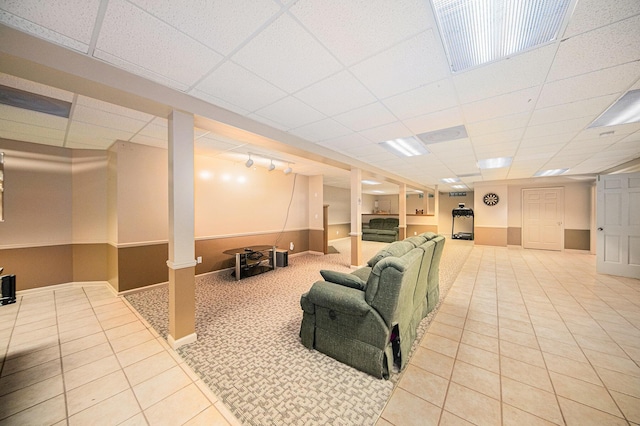 2925 Exmoor Rd, Ann Arbor, MI 48104 - living room with tile patterned floors, a paneled ceiling, and baseboards