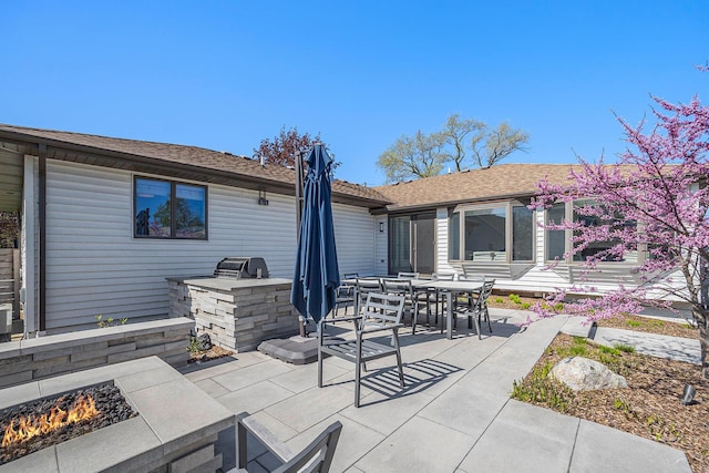 55 Gabriel Dr, South Haven, MI 49090 - rear view of property with area for grilling, an outdoor fire pit, a patio area, roof with shingles, and outdoor dining area