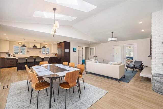 55 Gabriel Dr, South Haven, MI 49090 - dining area with vaulted ceiling, light wood-style flooring, a skylight, and recessed lighting
