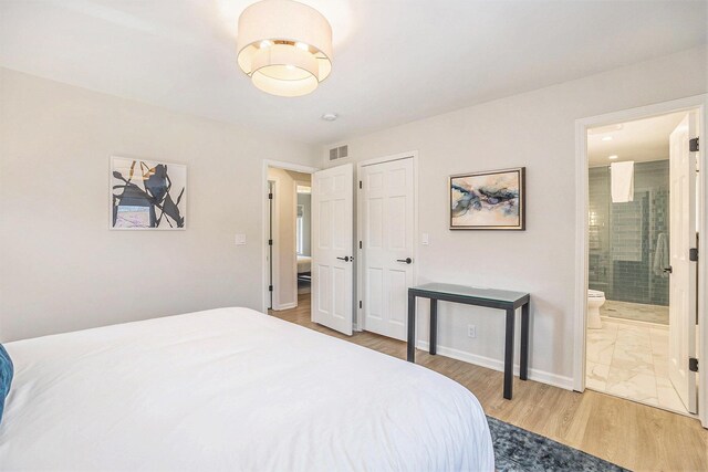 55 Gabriel Dr, South Haven, MI 49090 - bedroom with wood finished floors, ensuite bathroom, and baseboards