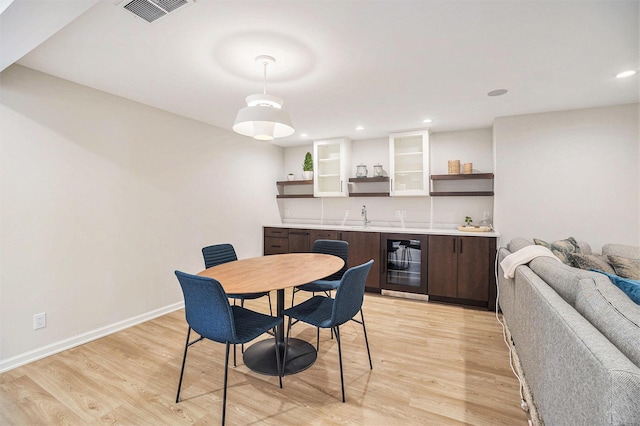 55 Gabriel Dr, South Haven, MI 49090 - dining area featuring wine cooler, light wood-style floors, wet bar, recessed lighting, and baseboards