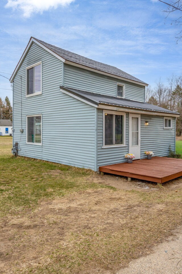 430 N Perry St, Barryton, MI 49305 - rear view of property featuring a wooden deck and a lawn
