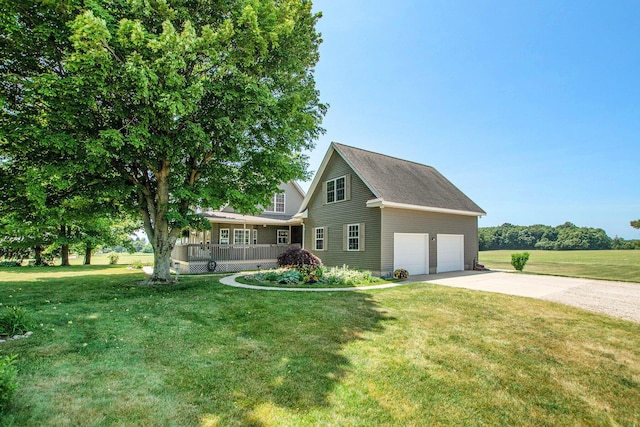 672 66th St, South Haven, MI 49090 - traditional home with a garage, a front yard, concrete driveway, and a porch