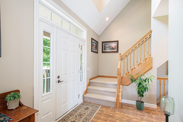 672 66th St, South Haven, MI 49090 - entryway featuring stairs, light wood-style floors, vaulted ceiling, recessed lighting, and a skylight