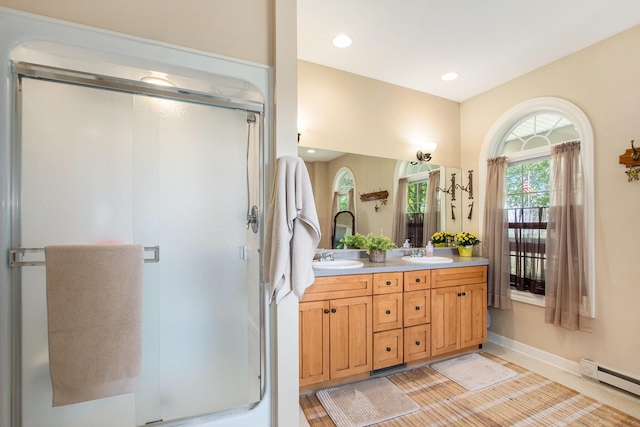 672 66th St, South Haven, MI 49090 - bathroom featuring double vanity, a stall shower, a baseboard heating unit, and recessed lighting