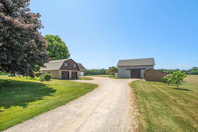 672 66th St, South Haven, MI 49090 - view of front of property featuring an outbuilding, a front lawn, dirt driveway, and a garage