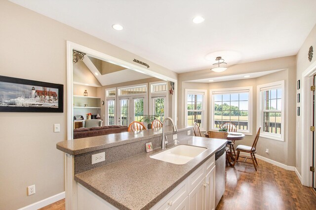 672 66th St, South Haven, MI 49090 - kitchen featuring stainless steel dishwasher, wood finished floors, white cabinetry, a center island with sink, and recessed lighting