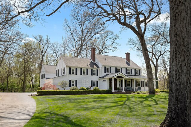 328 E 650 S, La Porte, IN 46350 - colonial house featuring covered porch, a chimney, and a front yard
