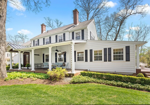 328 E 650 S, La Porte, IN 46350 - view of front facade with a porch, a ceiling fan, a front yard, and a chimney