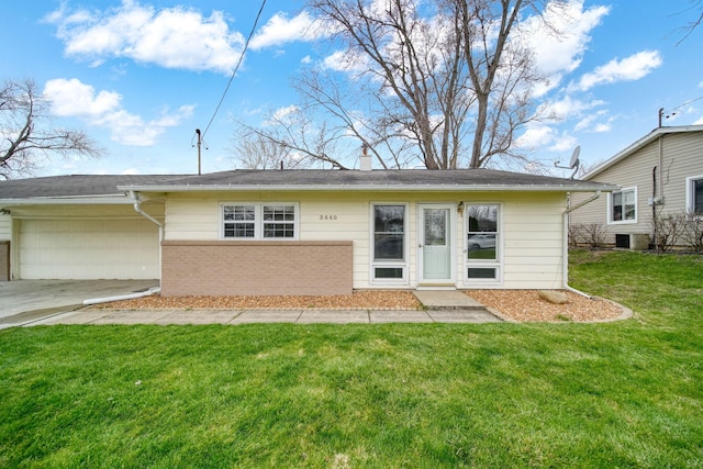 back of house featuring central air condition unit, an attached garage, a lawn, concrete driveway, and brick siding