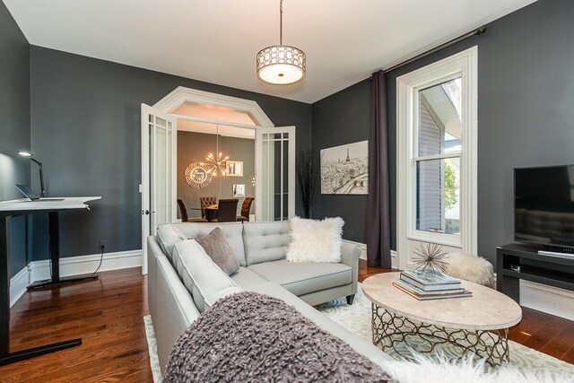 22 Jefferson Ave SE, Grand Rapids, MI 49503 - living area with a chandelier, wood finished floors, and baseboards